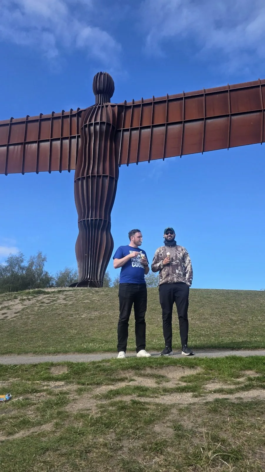 Two of the team at the foot of the Angel of the North