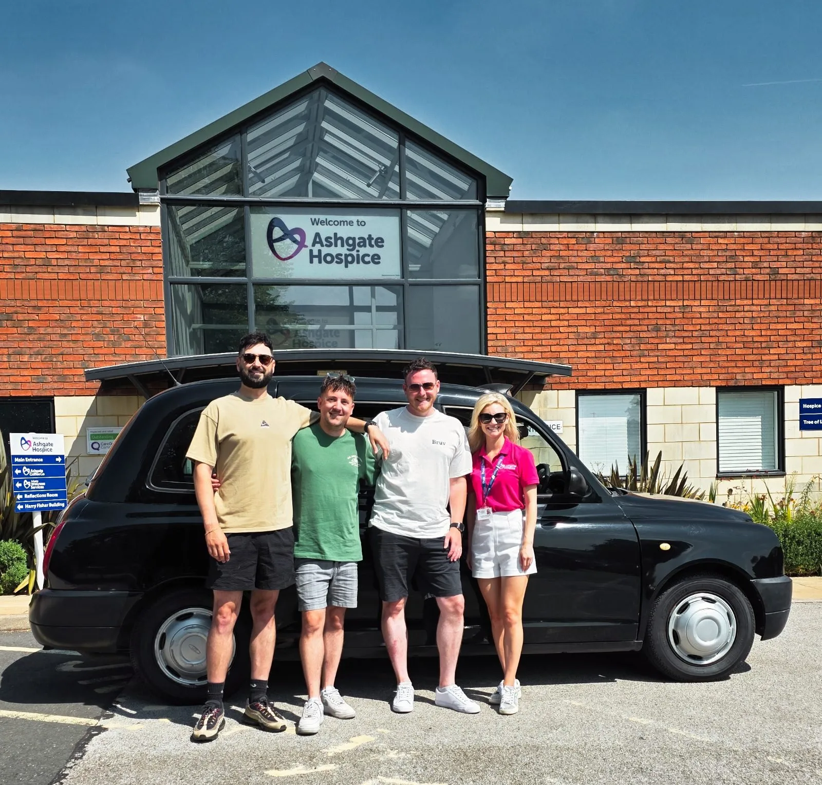 The three of us with a member of the Ashgate team, in front of the hospice with the cab before it was wrapped