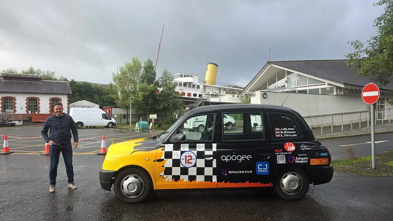 The taxi beside the Maid of the Loch paddle steamer on Loch Lomond