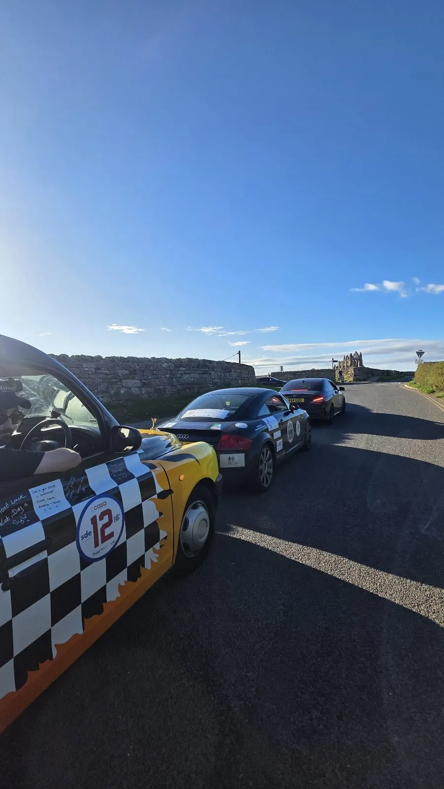 The rally convoy lined up on the road into Whitby, seen from the taxi