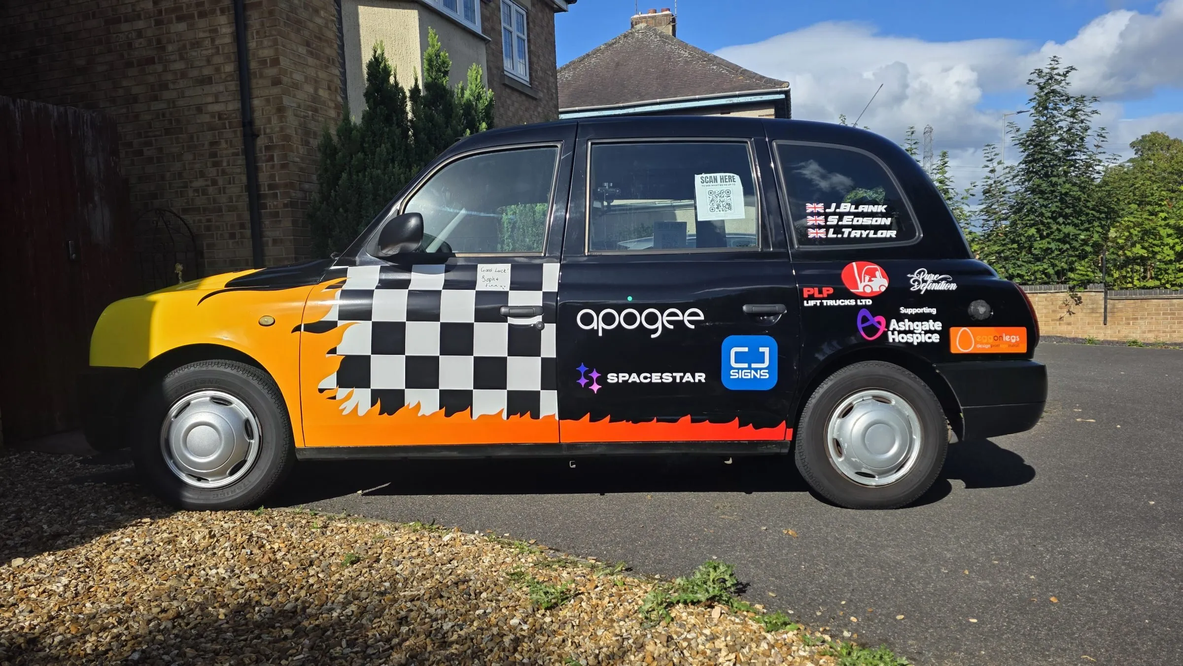 Our wrapped 2010 London taxi, in taxi yellow with chequered flags and sponsor logos